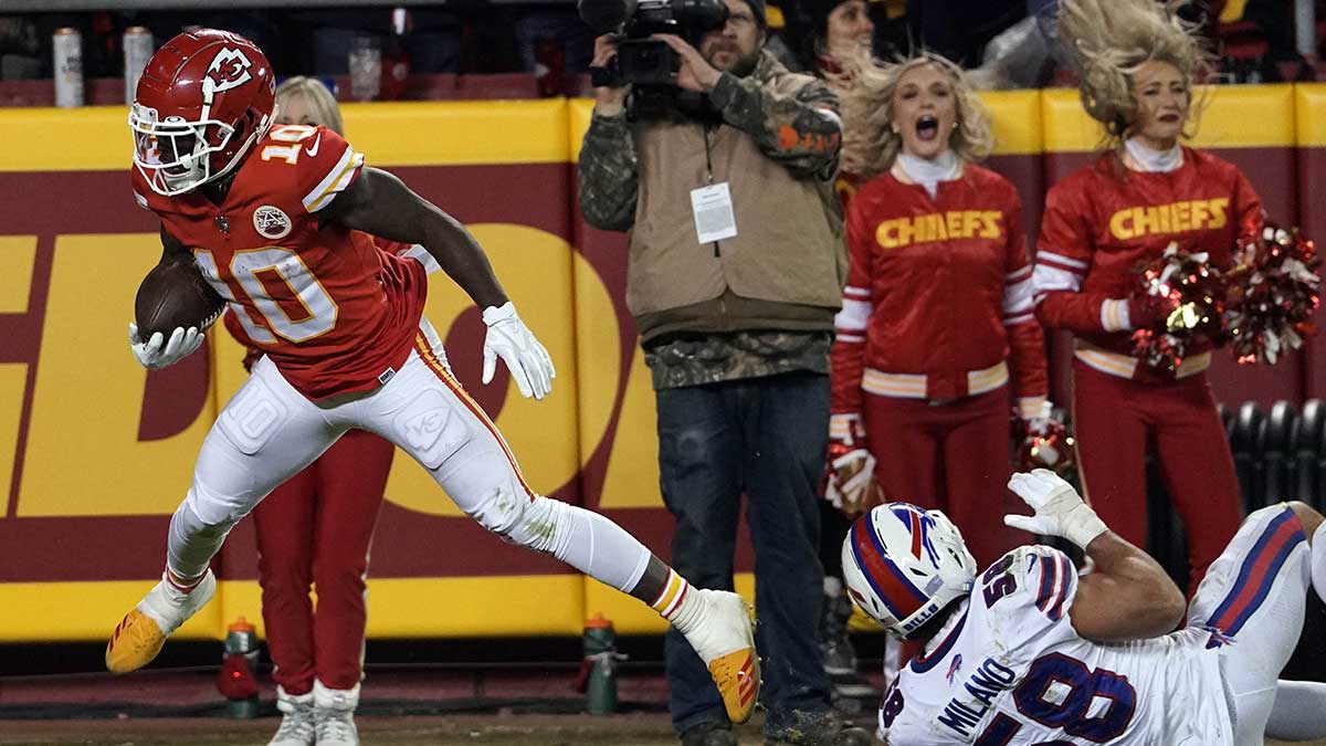 Kansas City Chiefs wide receiver Tyreek Hill (10) carries the ball up the field against the Buffalo Bills during the second half of the AFC Divisional playoff football game at GEHA Field at Arrowhead Stadium.