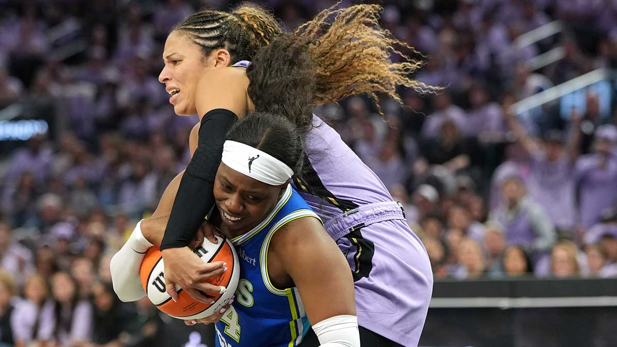 Oct 2, 2026; San Francisco, California, USA; Dallas Wings guard Arike Ogunbowale (bottom) and Golden State Valkyries guard Veronica Burton (top) battle for the ball during the fourth quarter of game three of the first round for the 2026 WNBA Playoffs at Chase Center. Mandatory Credit: Darren Yamashita-Imagn Images