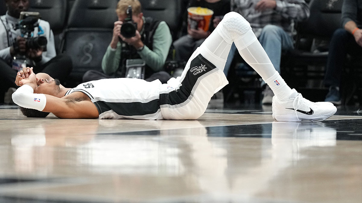 San Antonio Spurs forward Victor Wembanyama (1) lies on the floor after taking a flagrant foul during the first half against the Sacramento Kings at Frost Bank Center.